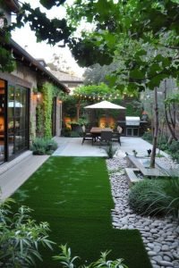 Landscaped backyard with artificial grass, patio, dining set, and stone pathway by MG Landscaping."